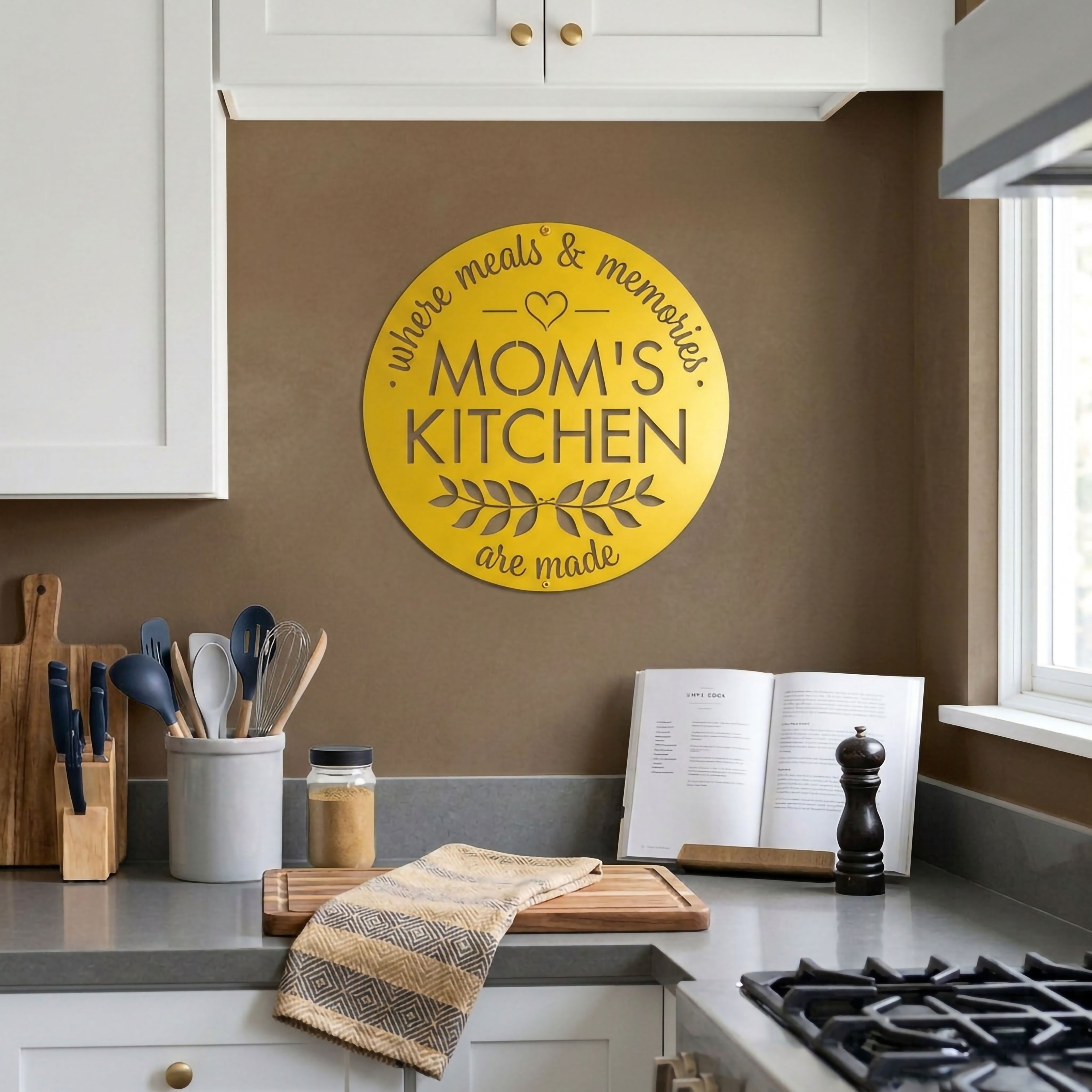 Spring yellow moms kitchen metal wall sign displayed in modern farmhouse kitchen with cooking utensils and countertop decor