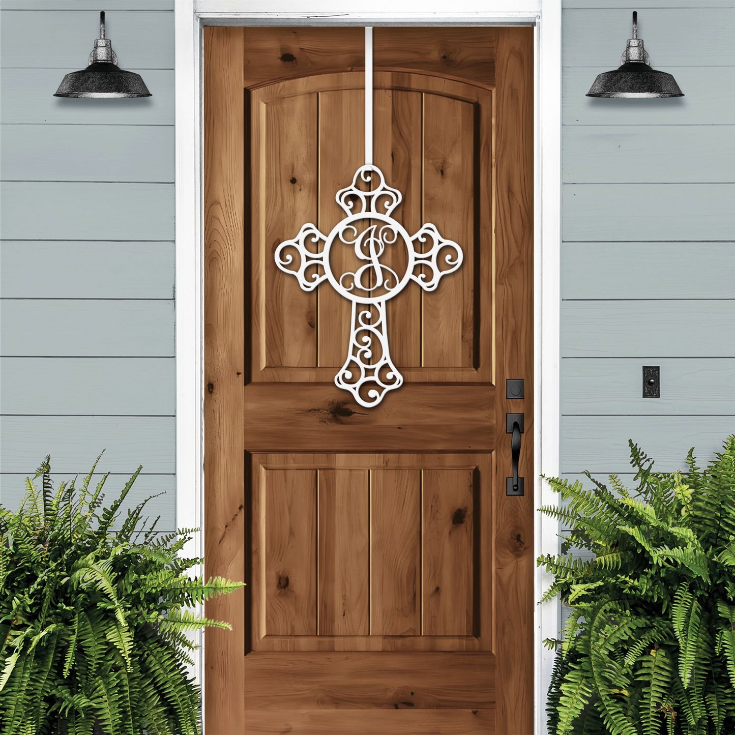 Custom Swirl Monogram Cross Door Sign displayed on a wooden door, featuring a personalized metal cross design for front door decor, showcasing craftsmanship and elegance for indoor and outdoor use.