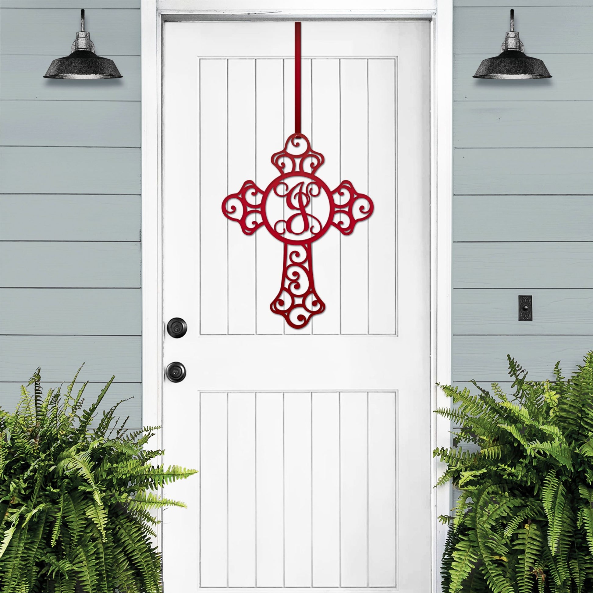 Custom Swirl Monogram Cross Door Sign displayed on a white door, featuring a personalized metal cross with a monogram letter. Ideal for front door, home, or garden decor, showcasing intricate craftsmanship.