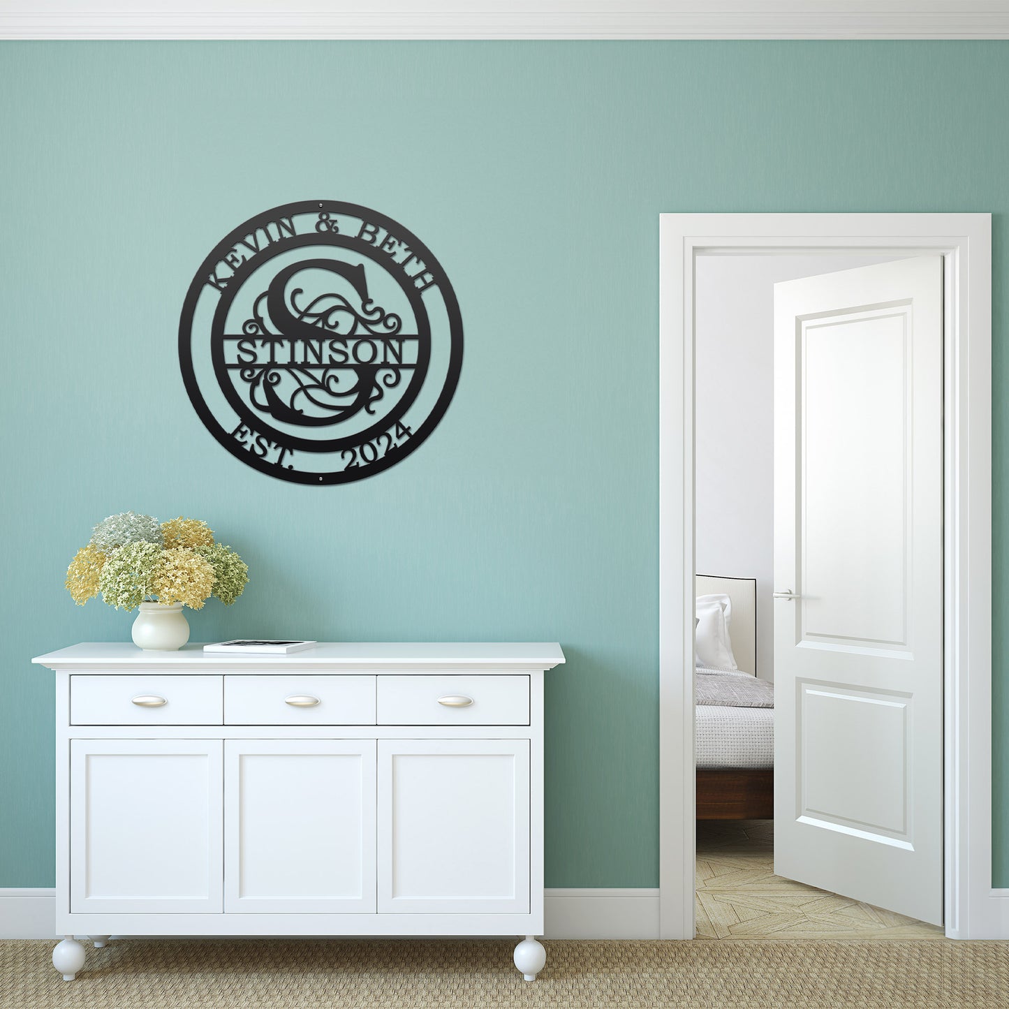 Couple's Monogram Established Sign displayed on a white cabinet with flowers, showcasing personalized family name monogram metal wall art, ideal as a wedding gift or home decor.