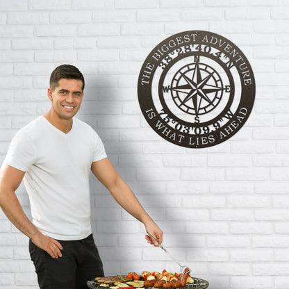 The Biggest Adventure Compass With Personalized GPS Coordinates Metal Sign, featuring a compass motif, elegantly displayed on a wall, symbolizing exploration and customizable with meaningful locations.