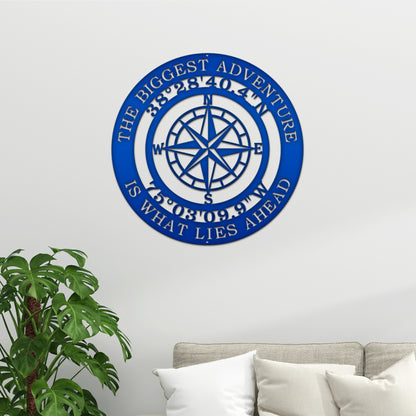 The Biggest Adventure Compass With Personalized GPS Coordinates - Nautical Wall Art features a detailed blue compass design on a metal sign, perfect for home or office decor.