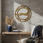 Gold The Fox Den metal wall art with running fox design mounted on a stone accent wall in a cozy reading nook