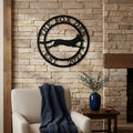 Black The Fox Den metal wall art with fox silhouette displayed on a stone fireplace wall above a cozy accent chair