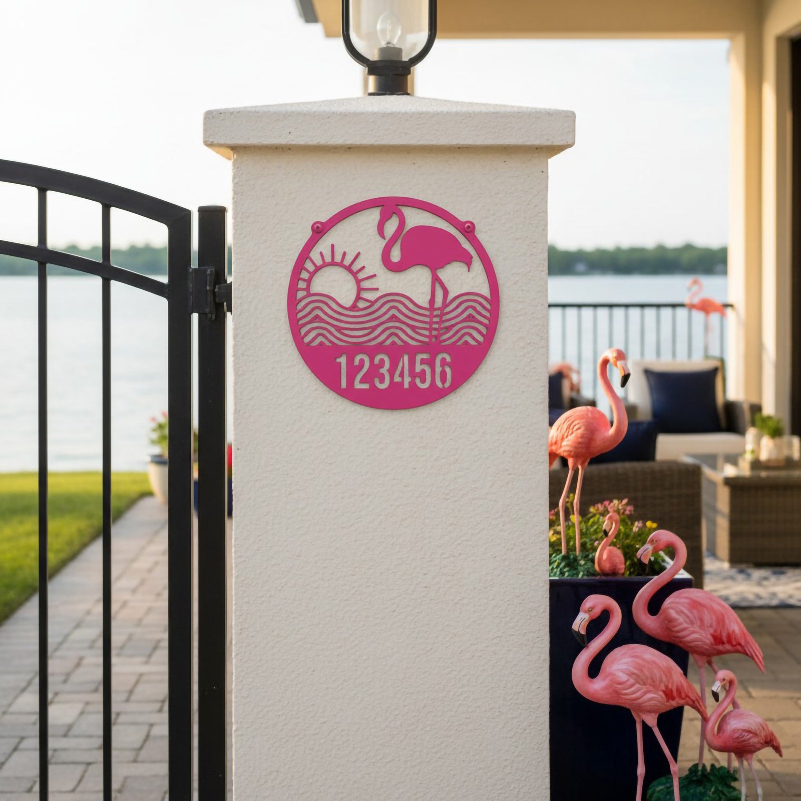 Sassy pink flamingo address plaque with number 123456 on lakeside gate pillar