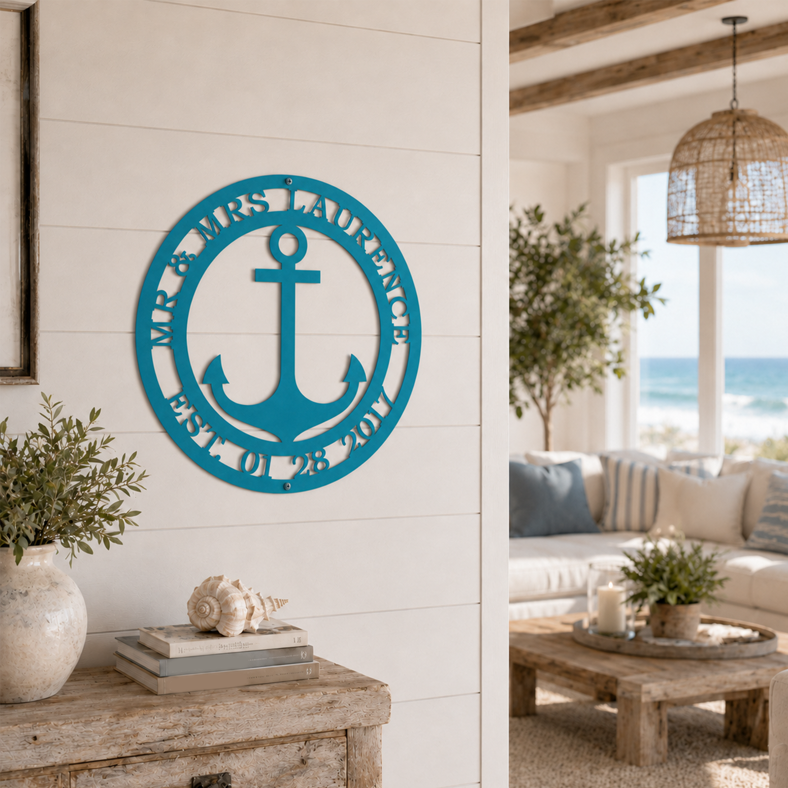Vibrant turquoise blue variation of the personalized Mr. & Mrs. anchor metal wall art styled above a rustic wood console table with a large conch shell.
