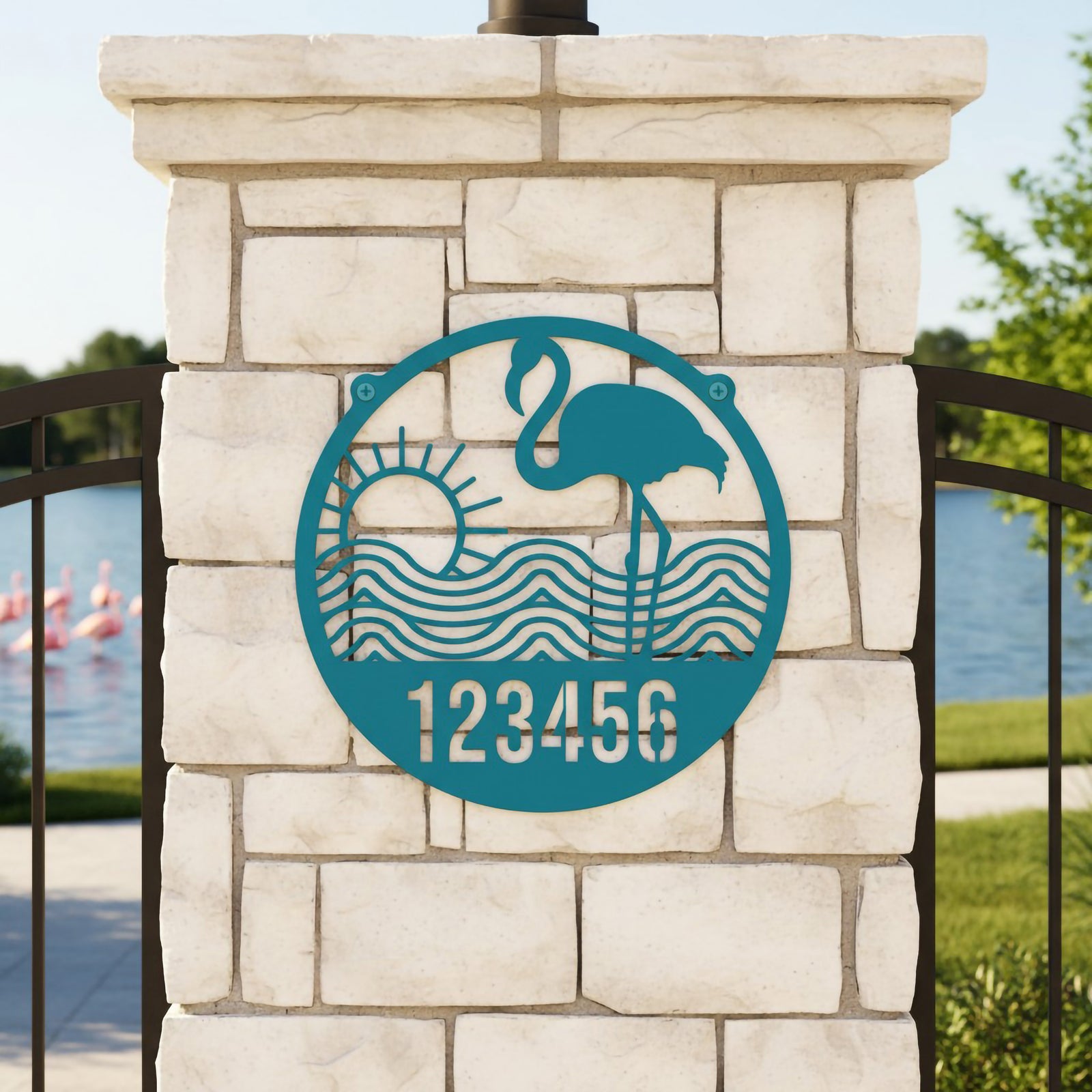 Turquoise flamingo metal address sign with sunset waves and number 123456 on stone pillar