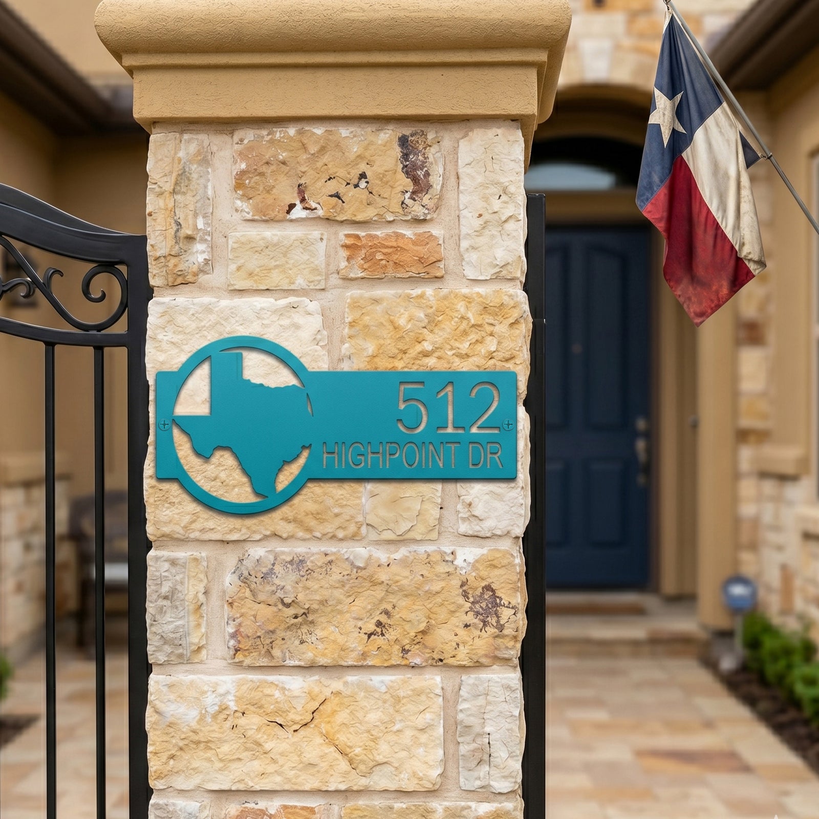 Custom Texas address metal sign in turquoise mounted on stone gate pillar with modern home exterior
