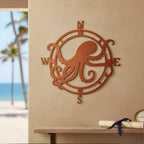 Copper orange custom metal octopus compass sign displayed on a warm beige wall above a wooden decorative shelf with a rolled vintage map and a beach view window.