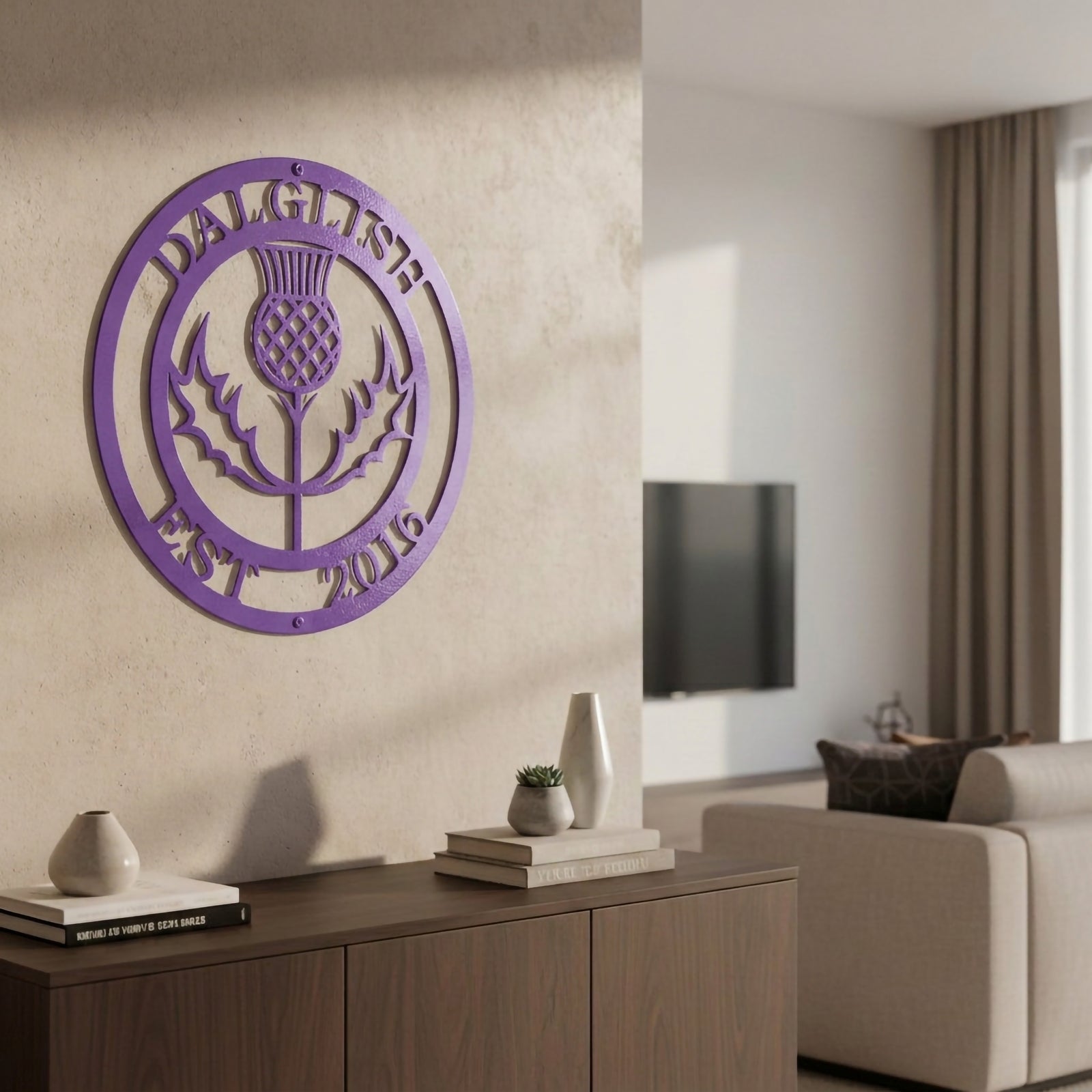Bright lilac purple finish of the custom personalized Scottish thistle metal sign styled on a neutral-toned wall above a dark wood entryway credenza.