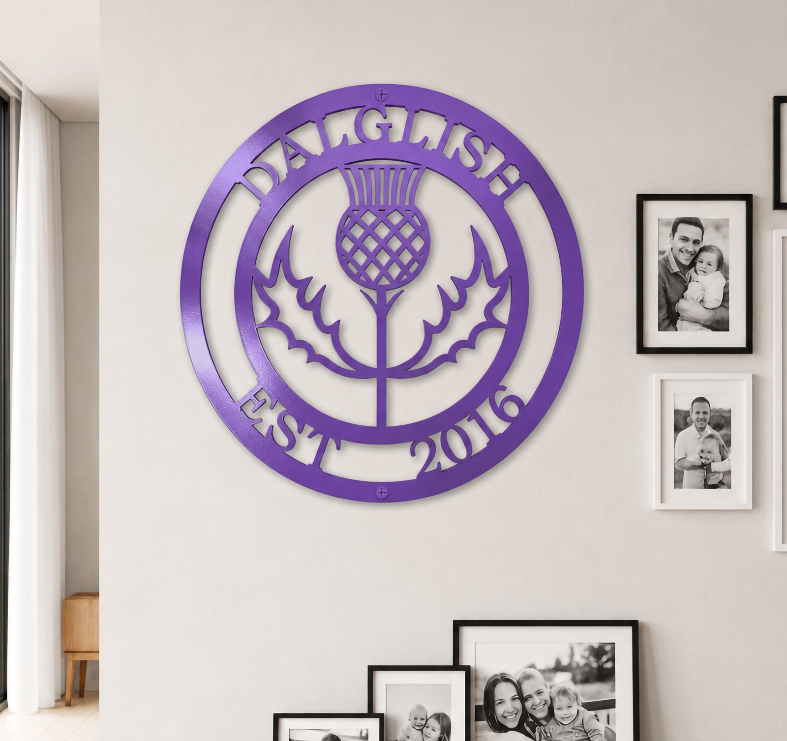 Bright lilac purple finish of the custom personalized Scottish thistle metal sign styled on a neutral-toned wall above a dark wood entryway credenza.