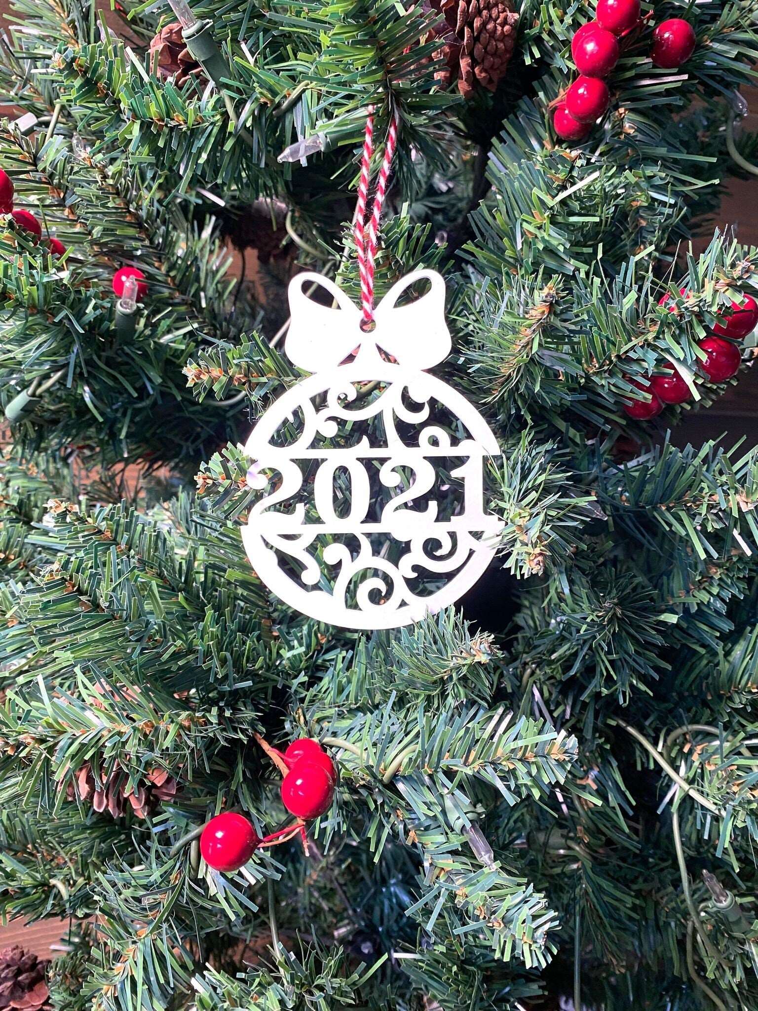 Decorative Christmas ornament with 2021 hanging on Christmas tree, festive holiday decoration for seasonal décor and commemorative ornament display