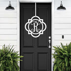 White monogram front door hanger with decorative letter R displayed on black door for custom porch entry decor