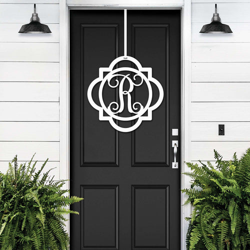 White monogram front door hanger with decorative letter R displayed on black door for custom porch entry decor