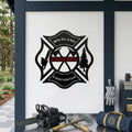 Custom wildland firefighter metal badge sign displayed on modern outdoor workstation with chainsaw axes and firefighting gear
