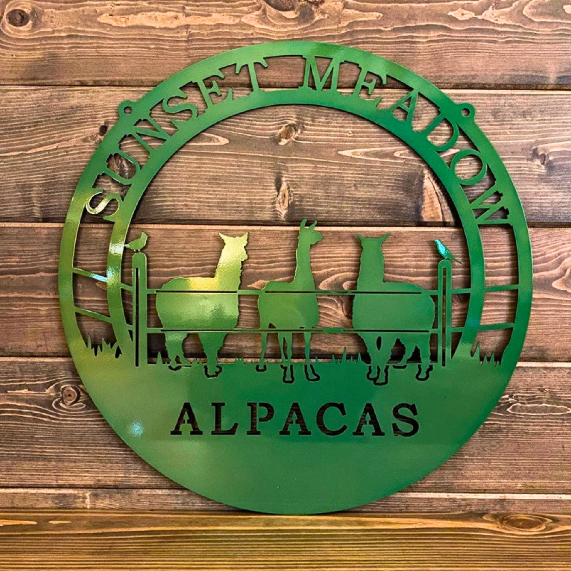 Emerald green custom laser cut metal ranch sign showing three alpacas behind fence, with “SUNSET MEADOW ALPACAS” text, outdoor farm decor.