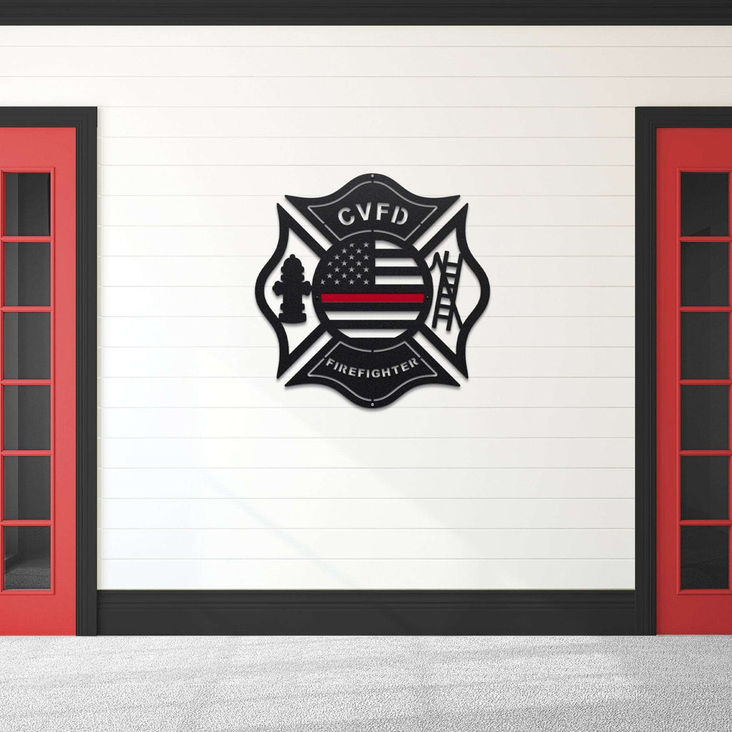 Firefighter Maltese Cross emblem with “CVFD” lettering and American flag design mounted on white wall with red doors, personalized décor, HouseSensationsArt