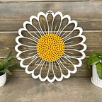 Daisy metal wall art with white petals and yellow center on wood backdrop, rustic farmhouse décor, custom color metal sign, modern outdoor home accent