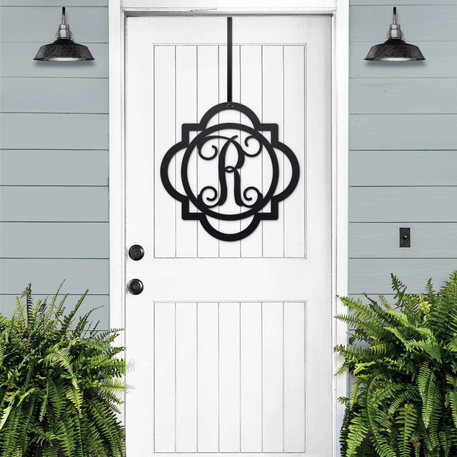 Black "R" metal monogram wreath displayed on a white front door – bold and modern farmhouse initial hanger.
