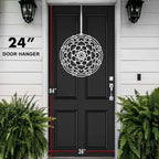 Black front door with white mandala pattern, measurement markings, modern home exterior design, white wall, decorative entryway art, cascading wreath style decor