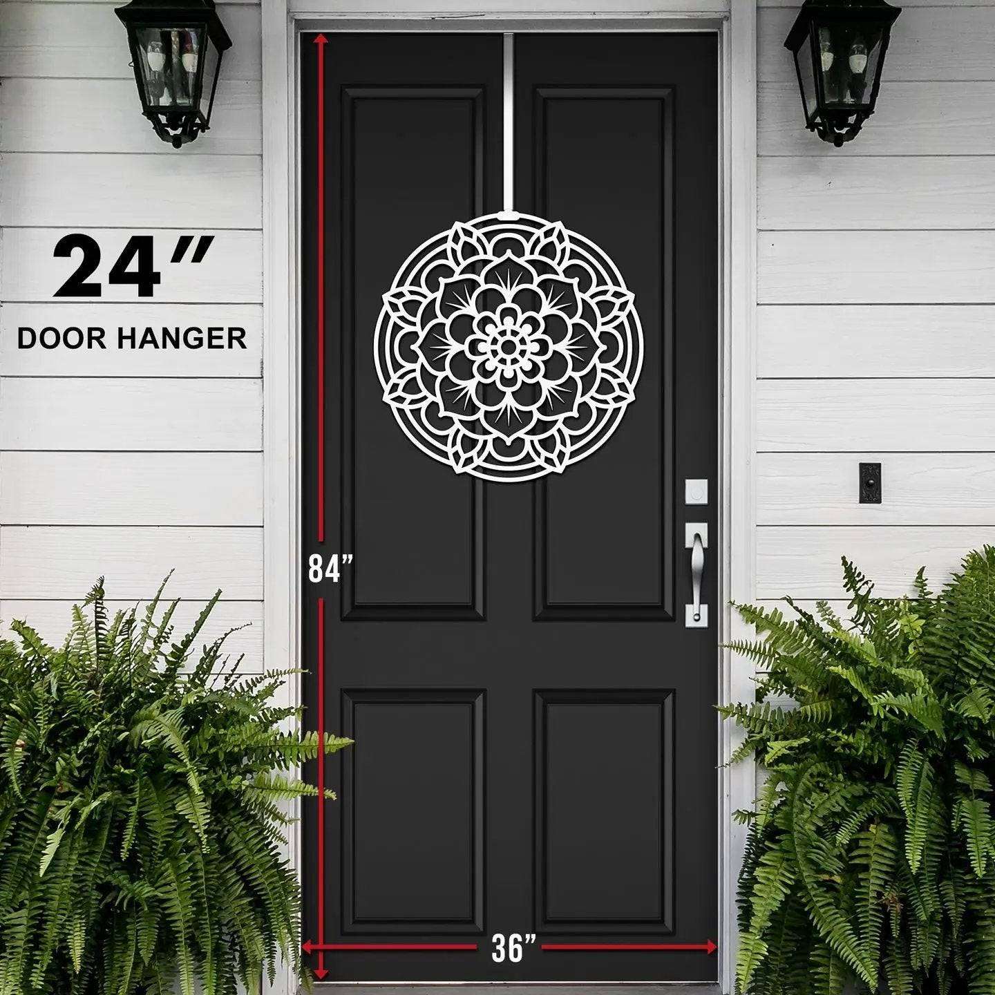 Black front door with white mandala pattern, measurement markings, modern home exterior design, white wall, decorative entryway art, cascading wreath style decor
