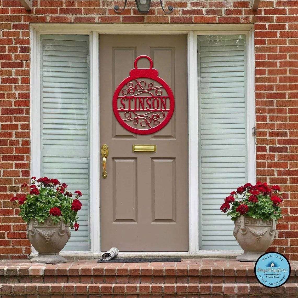 Red Christmas metal ornament sign on front door, holiday décor, personalized festive ornament, outdoor seasonal decoration, decorative door accent