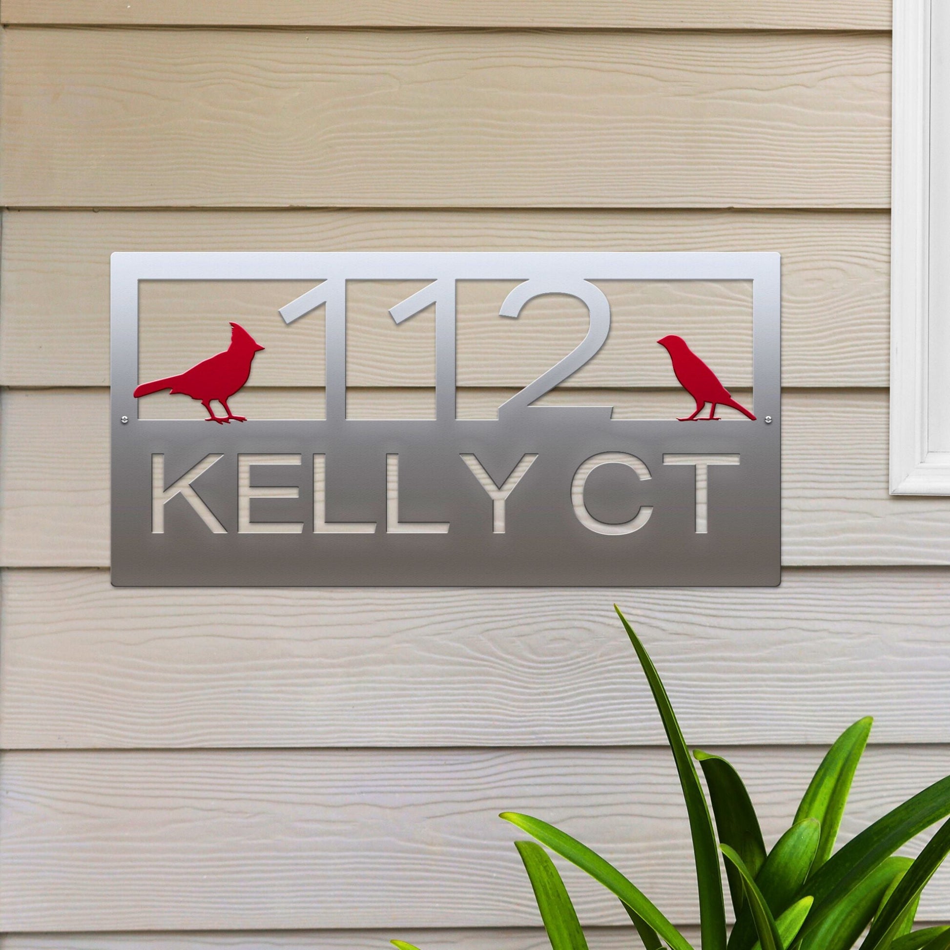Polished Chrome Classic Cardinal Address Sign featuring a red cardinal on each side, house number '112' in the center, and 'Kelly CT' below.