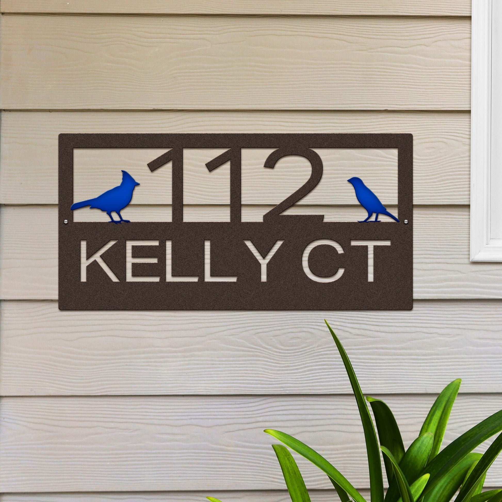 Oil rubbed bronze Classic Cardinal Address Sign featuring a blue cardinal on each side, house number '112' in the center, and 'Kelly CT' below.