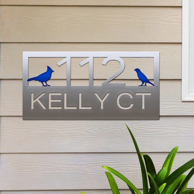 Polished Chrome Classic Cardinal Address Sign featuring a blue cardinal on each side, house number '112' in the center, and 'Kelly CT' below.