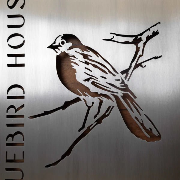 Metallic sign featuring bird design and text “Bluebird House” on metallic background, custom outdoor décor, decorative bird-themed house plaque