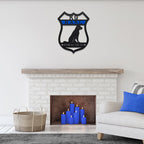 Decorative wall art displayed above a fireplace with blue candles in a living room setting, creating a cozy and stylish focal point.