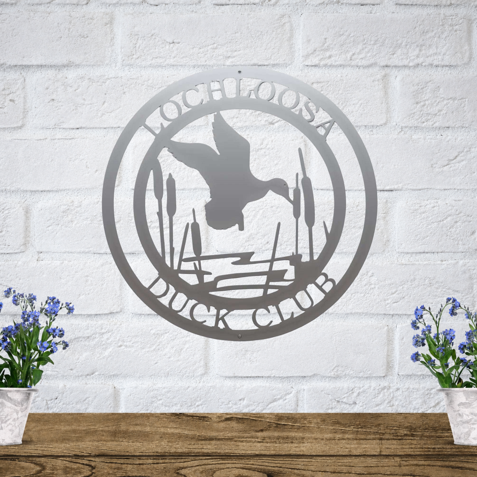 Silver gray duck club metal sign with flying duck silhouette and cattails for rustic cabin, lodge, or outdoor wall decoration