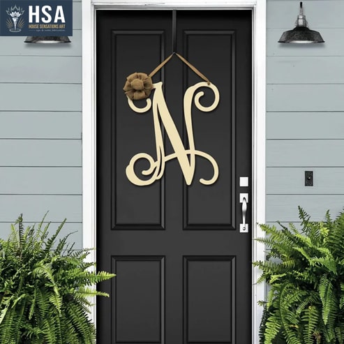 Metal monogram sign with the letter N being hanged in the front door