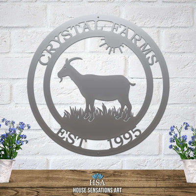 Custom gray goat metal sign for barns and farmhouses, outdoor décor with goat silhouette and 'Crystal Farms' text on white brick wall