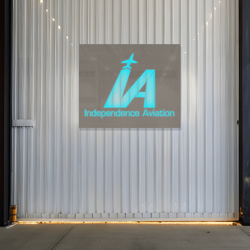 Custom light box sign featuring the Independence Aviation logo on a metallic surface