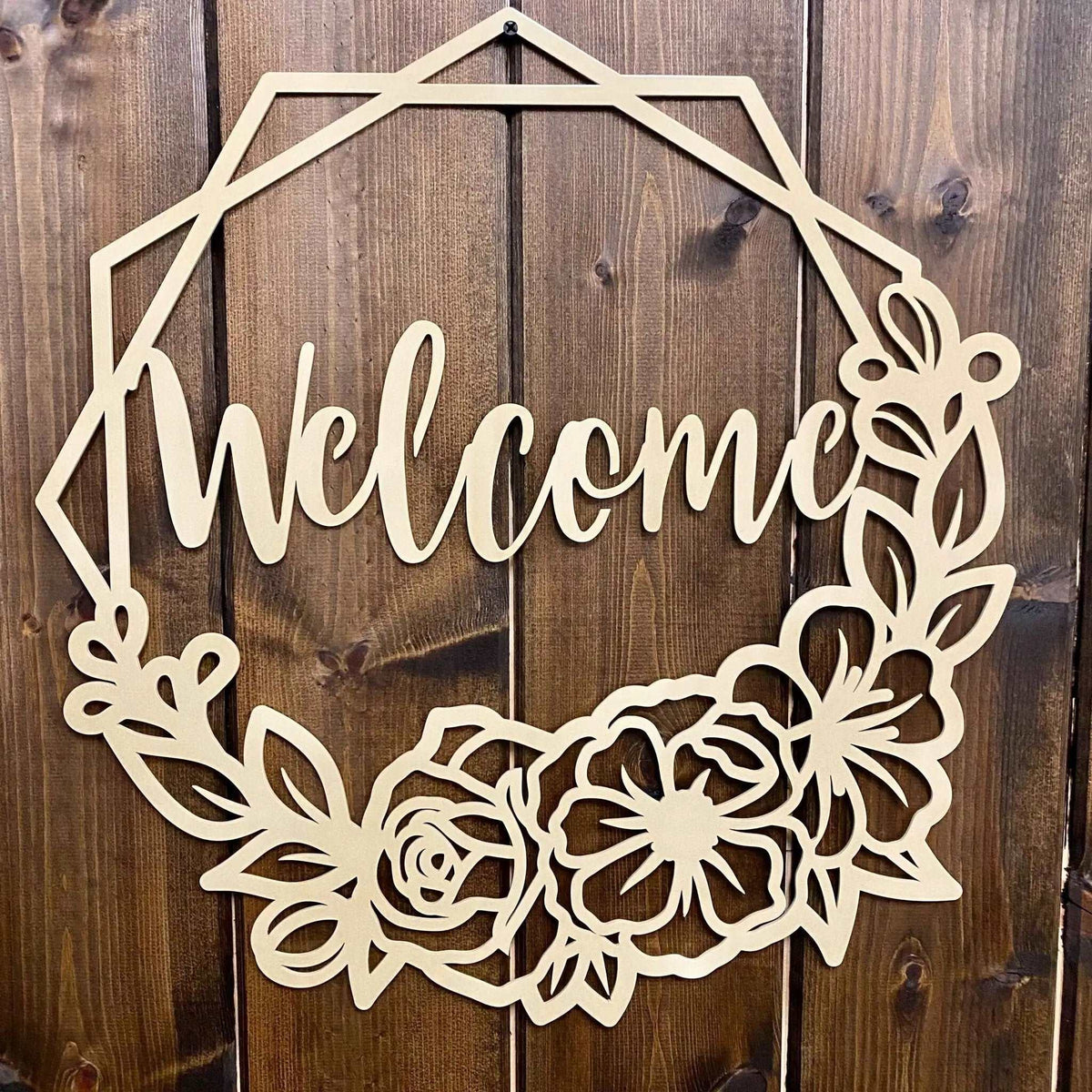Decorative wooden “Welcome” sign with floral designs on wooden background, custom indoor or outdoor home décor accent