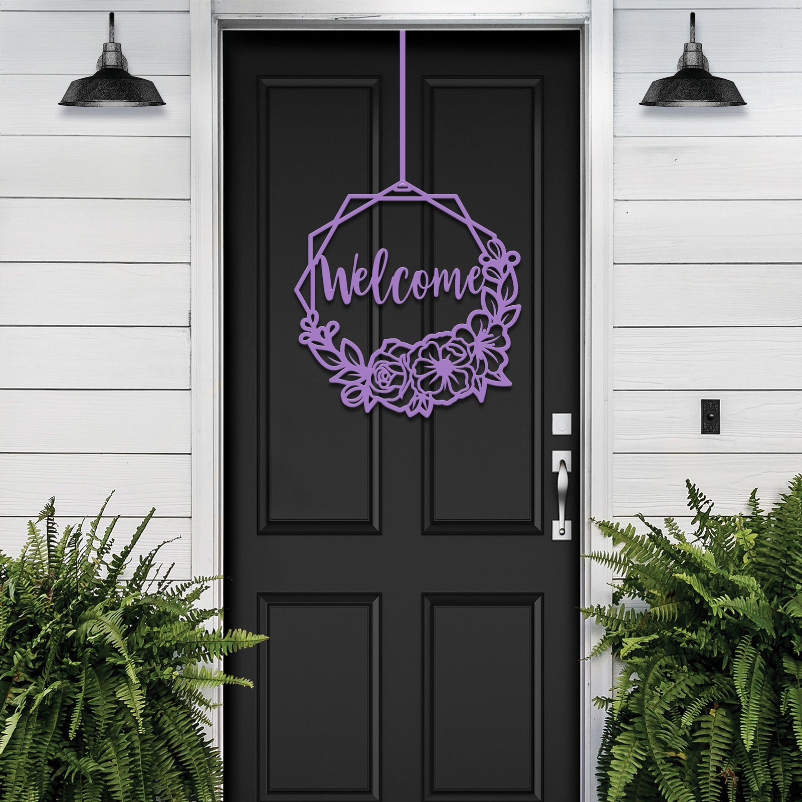 Decorative “Welcome” sign with floral design hanging on black door with white siding, custom outdoor home entrance décor