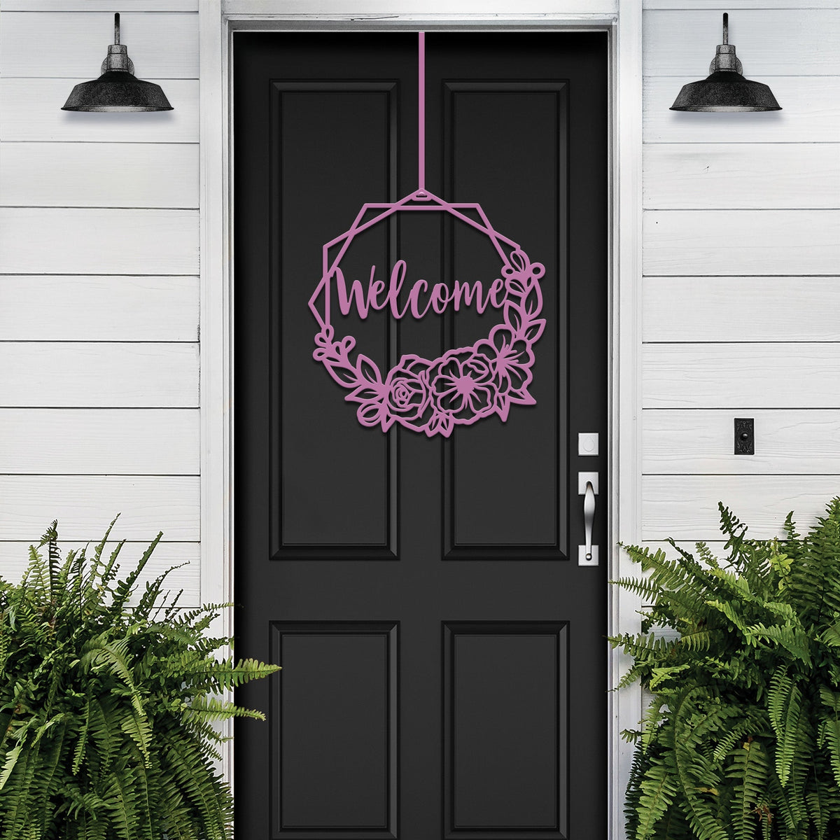 Decorative “Welcome” sign with floral design hanging on black door, custom outdoor home entrance décor