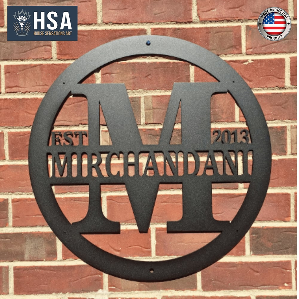 Custom metal gate sign with “Mirchandani” and HSA branding, personalized family or business décor mounted on brick wall exterior.