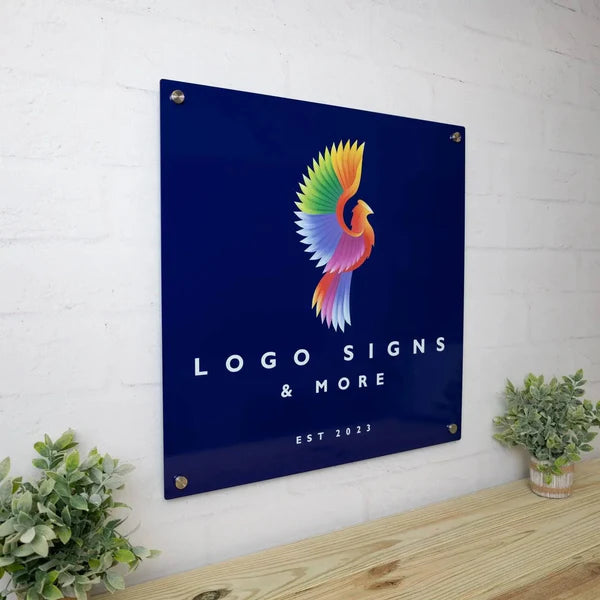 Side view of square sign with colorful bird logo, 'LOGO SIGNS & MORE' and 'EST 2023,' wall-mounted with screws.