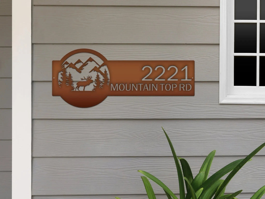 Decorative house number sign with nature-themed design on house exterior, rustic outdoor moose cabin metal decor