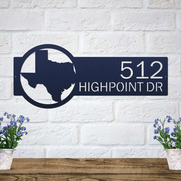 Decorative metal house number sign with Texas outline and text mounted on a white brick wall for outdoor décor, HouseSensationsArt