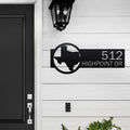 Personalized metal house number sign with Texas outline mounted on a white exterior wall for outdoor decor, HouseSensationsArt