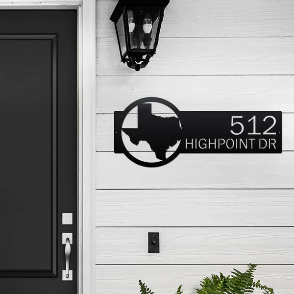 Personalized metal house number sign with Texas outline mounted on a white exterior wall for outdoor decor, HouseSensationsArt