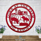 Decorative metal farm sign with pig scene and “Down at the Pig Farm Pig Resort” text on white brick wall, front door outdoor plaque, rustic décor
