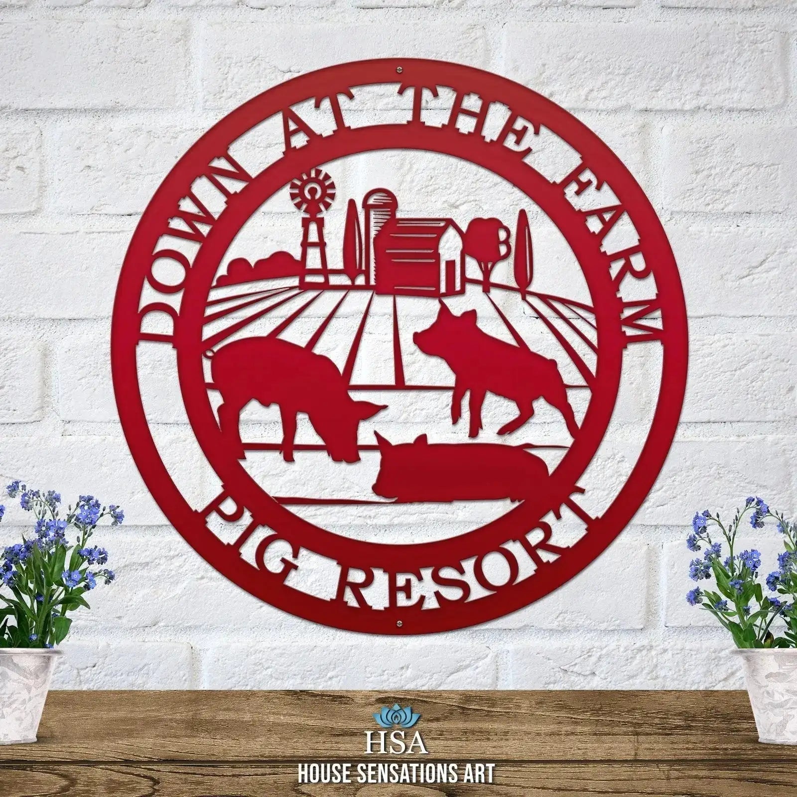 Decorative metal farm sign with pig scene and “Down at the Pig Farm Pig Resort” text on white brick wall, front door outdoor plaque, rustic décor
