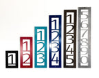 Sample set of personalized metal house number plaques in multiple colors, displayed on a white background, ideal for gates, mailboxes, garages, and custom home décor.