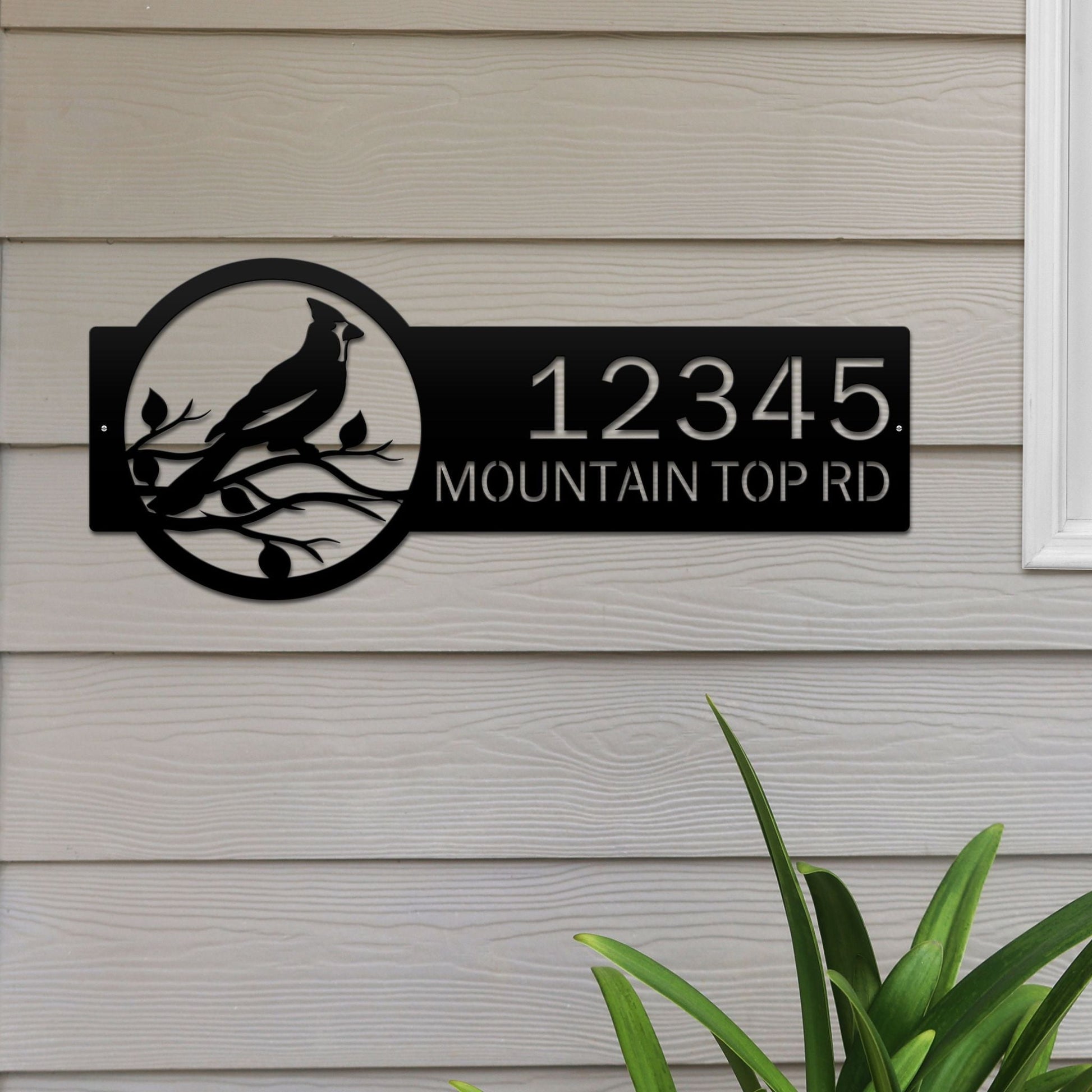 Black Custom Cardinal Address Sign with cardinal on leafy branch on right and house number '12345 Mountain Top Rd' on left.
