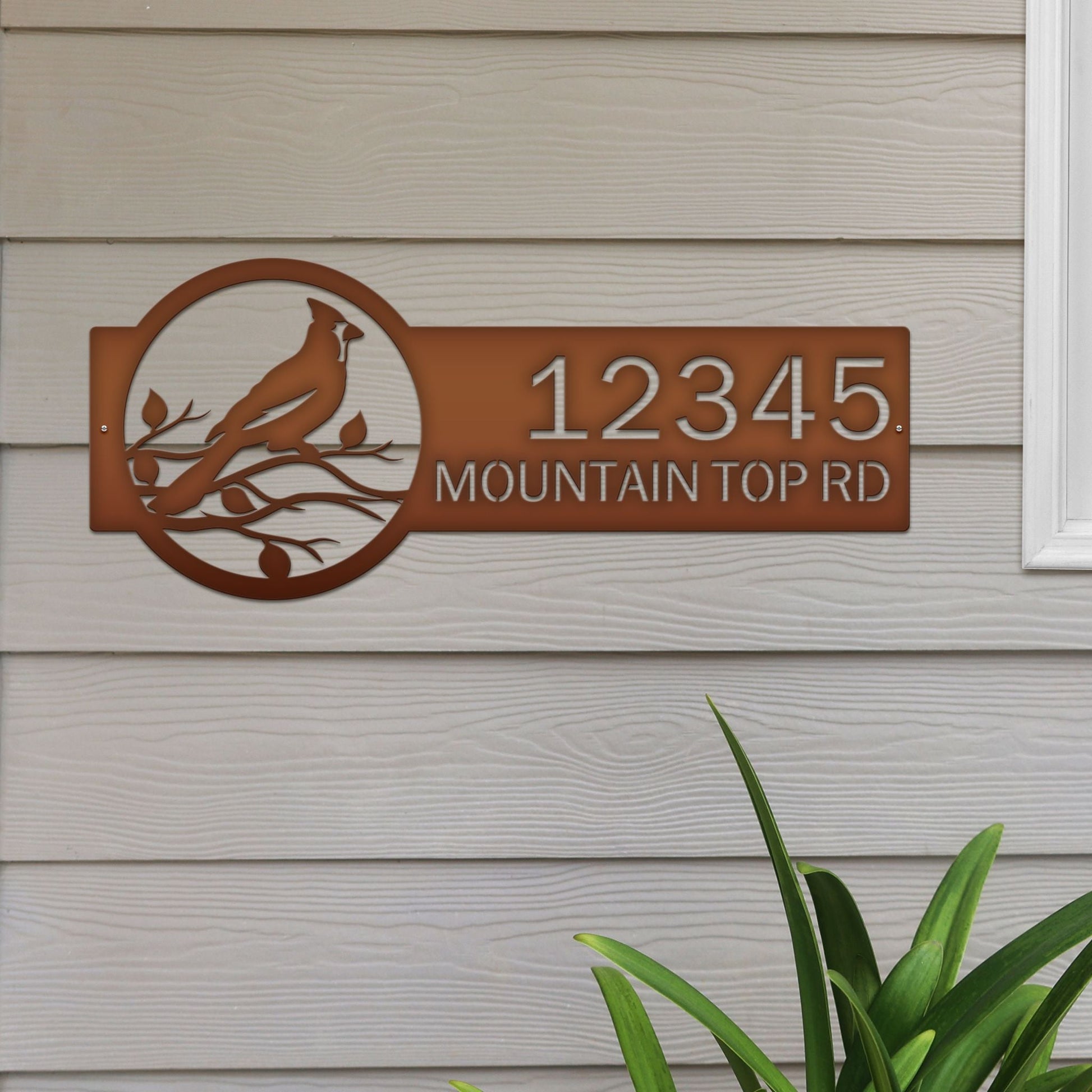 Candy copper Custom Cardinal Address Sign with cardinal on leafy branch on right and house number '12345 Mountain Top Rd' on left.