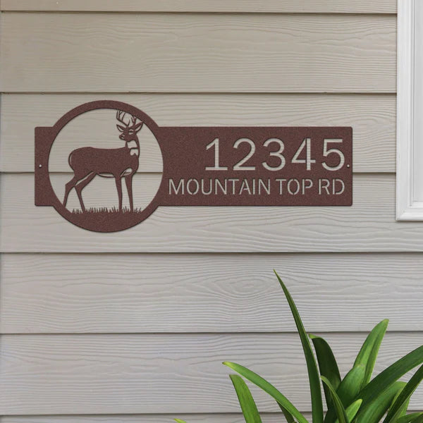 Candy copper address sign with deer on right and '12345 Mountain Top Rd' on left in bold, easy-to-read lettering.